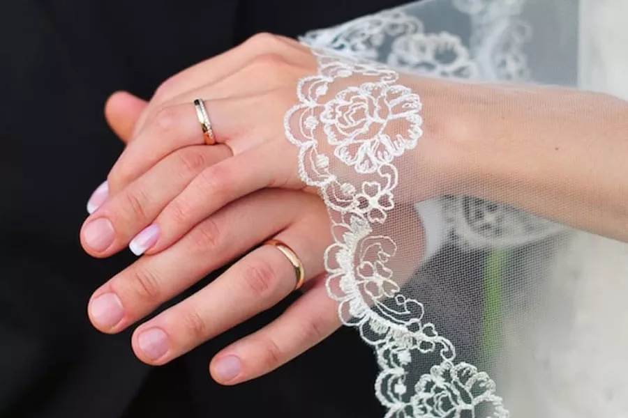 Wedding bands worn by a newly married couple
